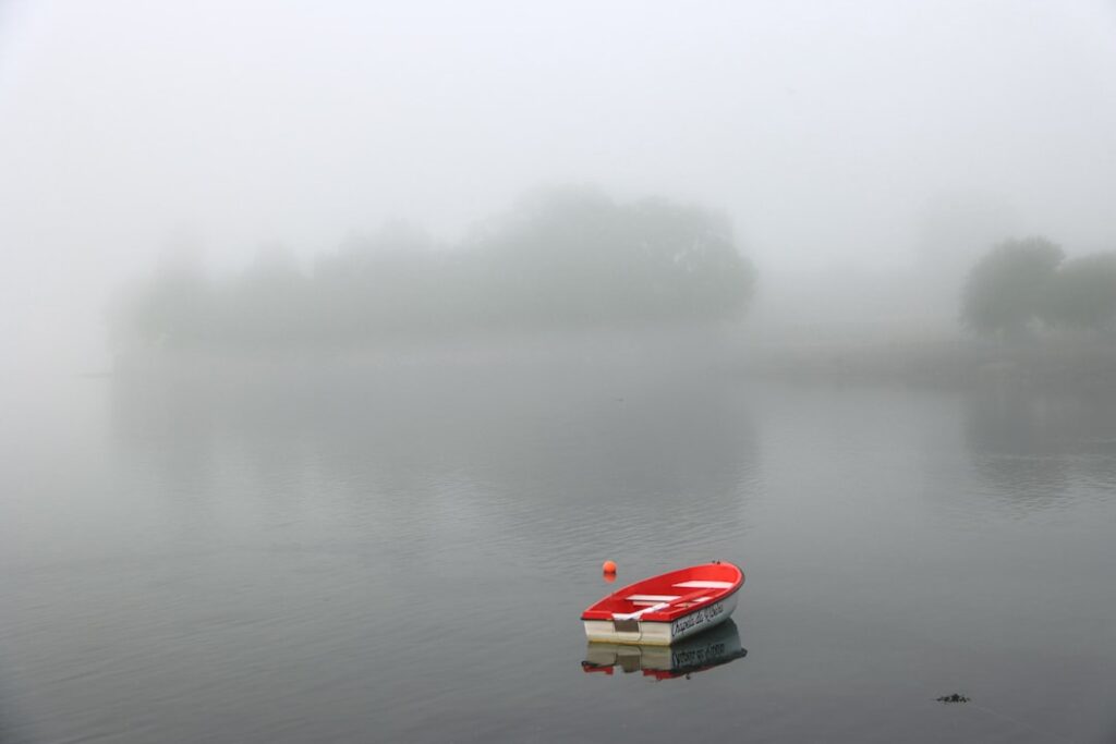 Lake Como foggy shore small boat