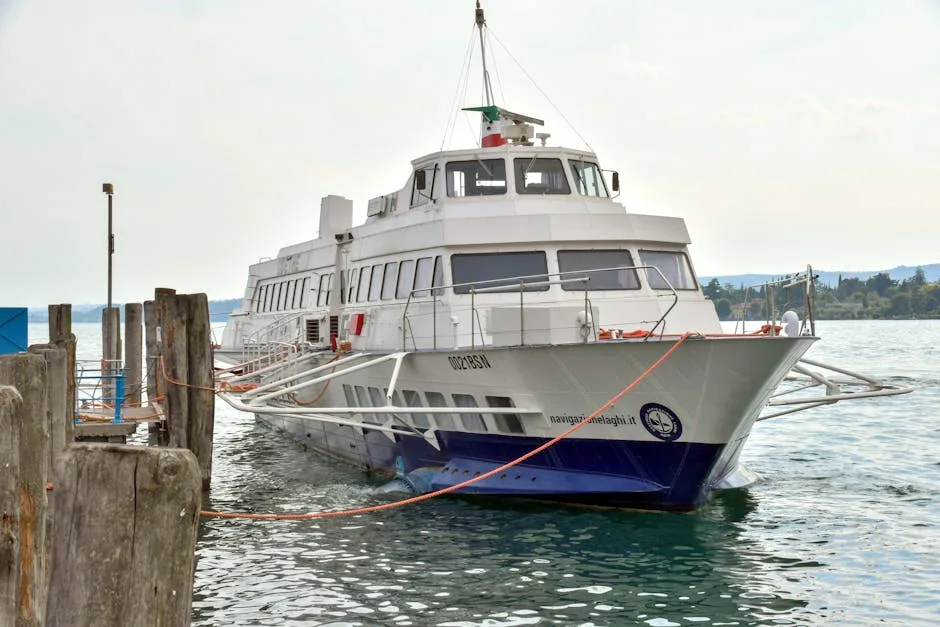 White Lake Como ferry moored at a wooden pier on calm water.