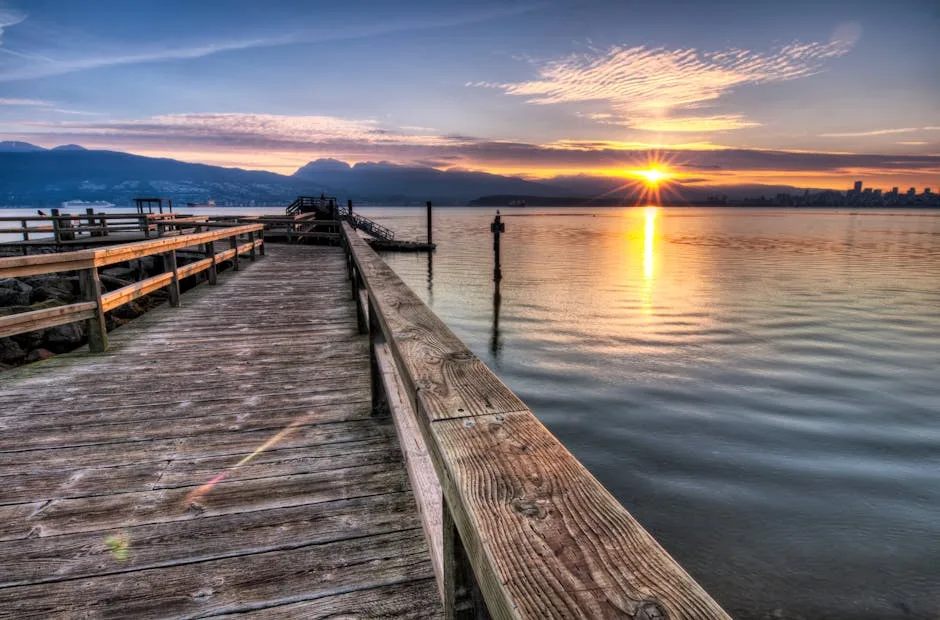 Wooden pier leading toward sunrise over Lake Como and distant mountains